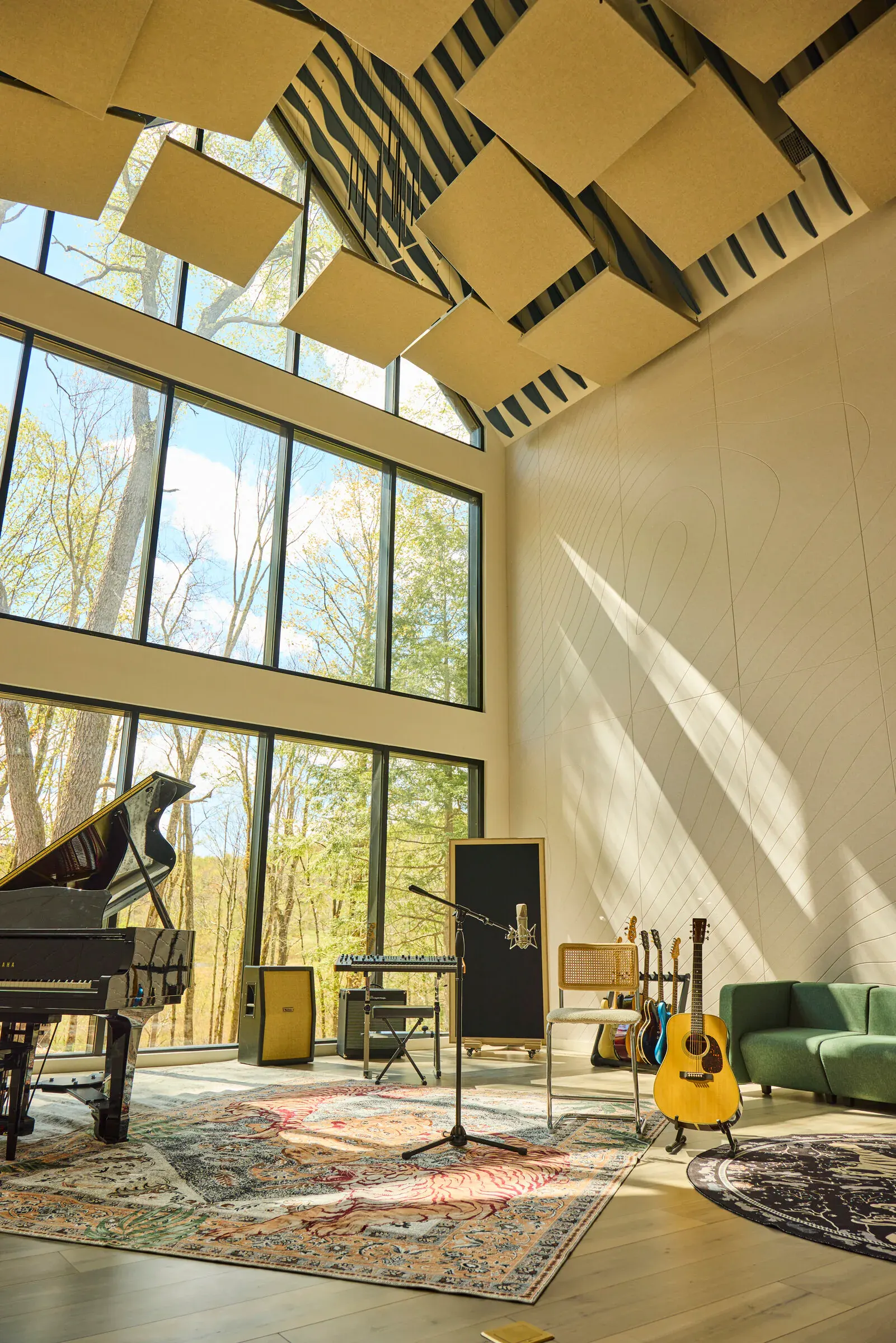 Verdant Sound live room — wide view with 40-foot cathedral ceiling, acoustic panels, and guitars on a tiger rug